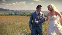 Bride and Groom walking through a meadow- Ashleigh & Rachel - Glyn Clydach Hotel - Wedding