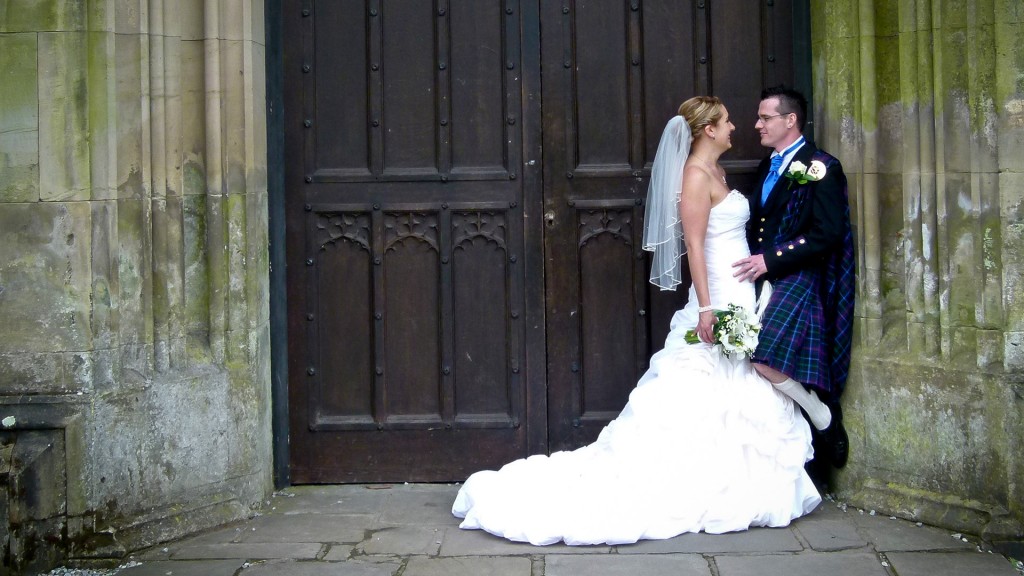 Bride and Groom standing in the doorway of Margam Castle just after getting married in Margam Orangery
